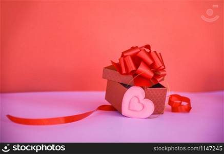 Open Gift Box red with pink heart / red present box with red ribbon bow for gift to Merry Christmas Holiday Happy new year or Valentines day on red background