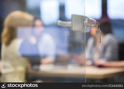 Open glass door with keys, key in keyhole