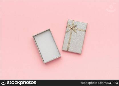 Open gray gift box with bow on pink pastel background in minimal style. Top view Copy space Mockup.. Open gray gift box with bow on pink pastel background in minimal style. Top view Copy space Mockup