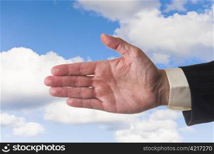 Open hand of man, cloudy sky background.