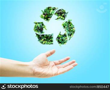 Open hand with green leaf recycle icon on light blue background.