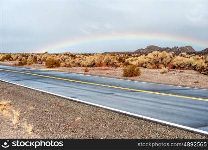 Open highway and rainbow in California, USA.
