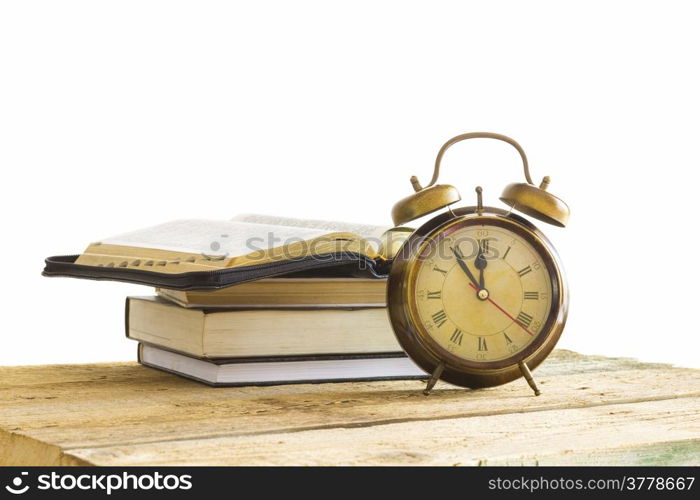 open Holy Bible with clock on wood with white background