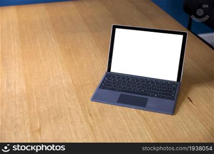 Open laptop isolated white screen for copy space on wooden office desk with copy space. work space home or office space for text advertisement. Open laptop isolated white screen for copy space on wooden office desk with copy space. work space home or office