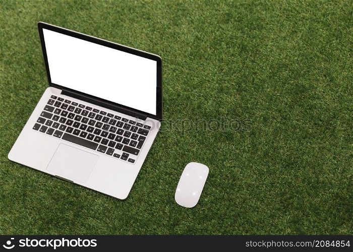 open laptop mouse artificial grass background