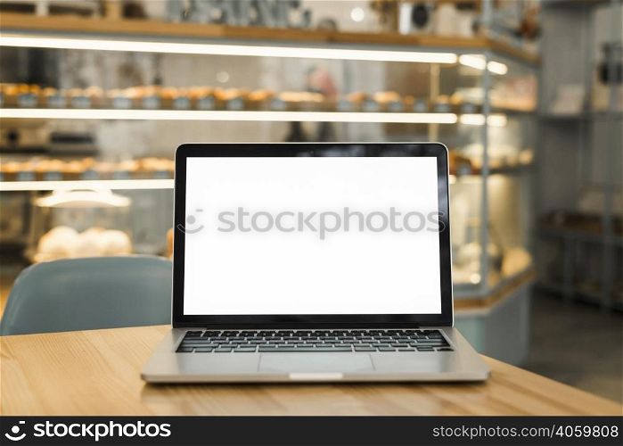 open laptop with blank white screen display table coffee shop