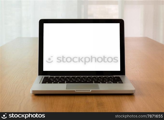 Open laptop with isolate screen on wooden desk with natural light coming through the window, Mock up concept and idea.