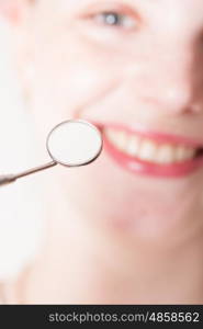 Open mouth of woman with dentist mirror during checking teeth. Check the teeth