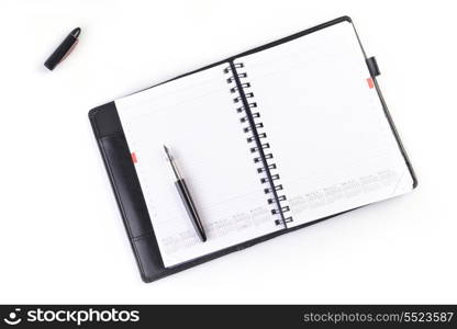 open notebook and black pen on white background