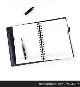 open notebook and black pen on white background
