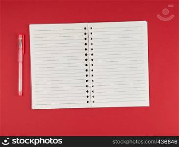 open notebook in line and gel pen on a red background, top view, empty white sheets