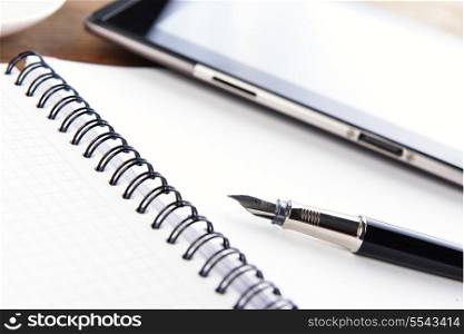 open notebook, mobile phone and black pen on white background