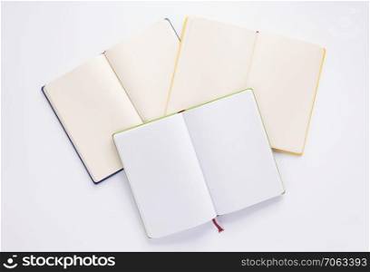 open notebook or book with empty pages on white  background, top view