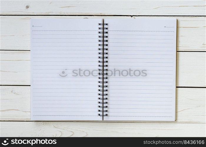 Open notebook with blank pages on wood table