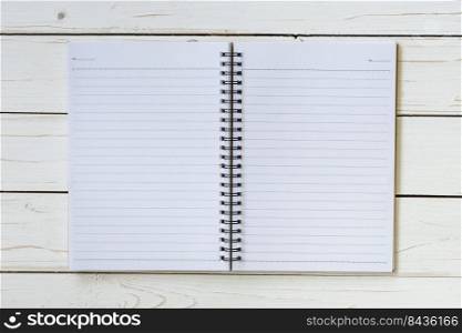 Open notebook with blank pages on wood table
