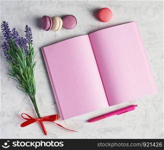 open notebook with blank pink pages, red pencil and a bouquet of lavenders on a white background, top view, flat lay