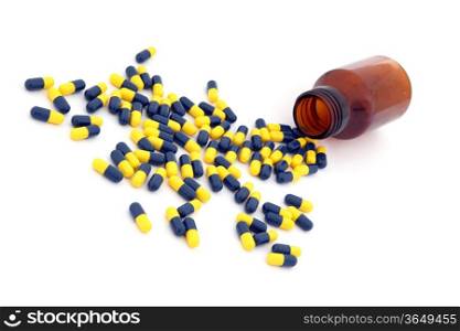 open pill bottle with capsules spilling out of it isolated on white