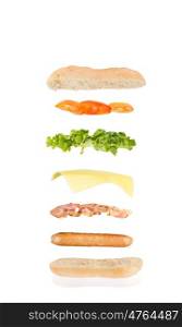 open sandwich, floating sandwich, hot dog sandwich with sausage, bacon, cheese, lettuce and tomato