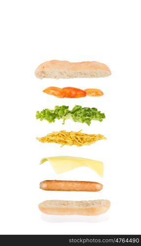 open sandwich, floating sandwich, hot dog sandwich with sausage, cheese, chips, lettuce and tomato