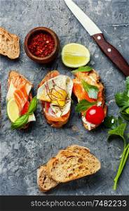 Open sandwich with salmon and vegetables.Delicious toasts with salmon. Open sandwich with fish