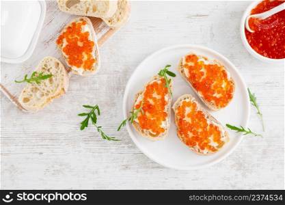 Open sandwiches with red salmon caviar. Top view, flat lay