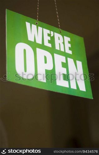 Open sign on the glass of the door at the store