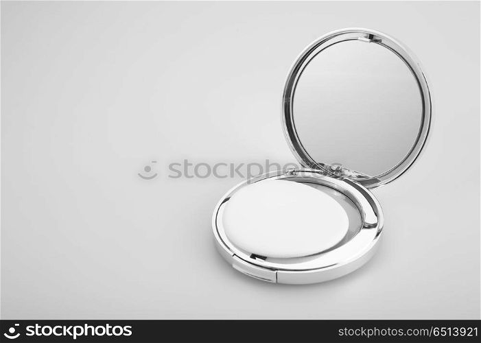 Open silvery packing of the compact powder, isolated. Cosmetics