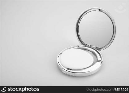 Open silvery packing of the compact powder, isolated. Cosmetics
