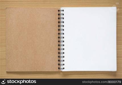 open spiral notebook on wood background