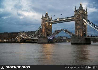 Open Tower Bridge against stormy sky