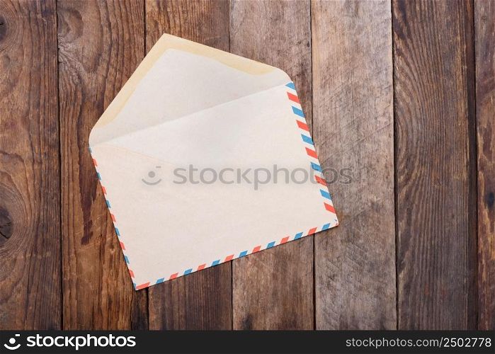 Open vintage envelope on old wooden table still life
