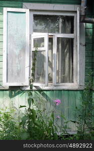 Open window of uncared country house (dacha) in Russia