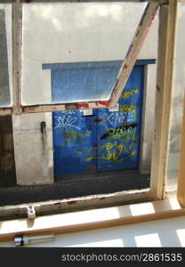 Open window with a view of a blue door on the street