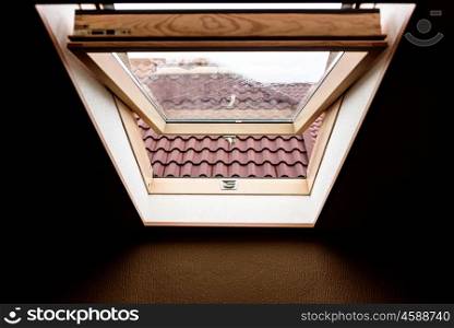 open wooden attic window overlooking the street
