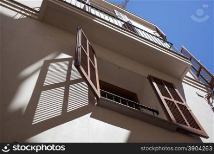 Open wooden window in hot summer day with shadow on the wall. Open wooden window in hot summer day