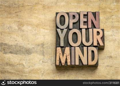 open your mind - word abstract in vintage letterpress wood type blocks on textured bark paper with a copy space