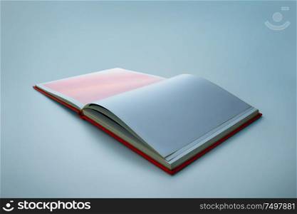 Opened blank square book isolated on blue backgroung .