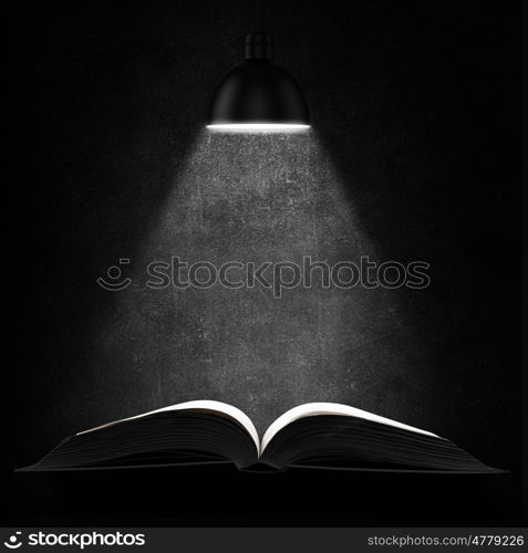 Opened book. Old opened book and lamp hanging above