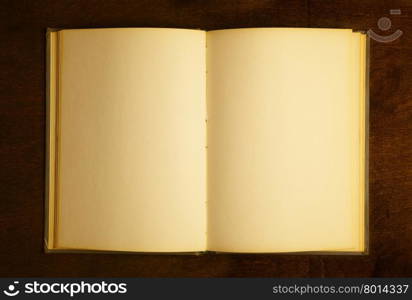 Opened book with blank pages on wooden table