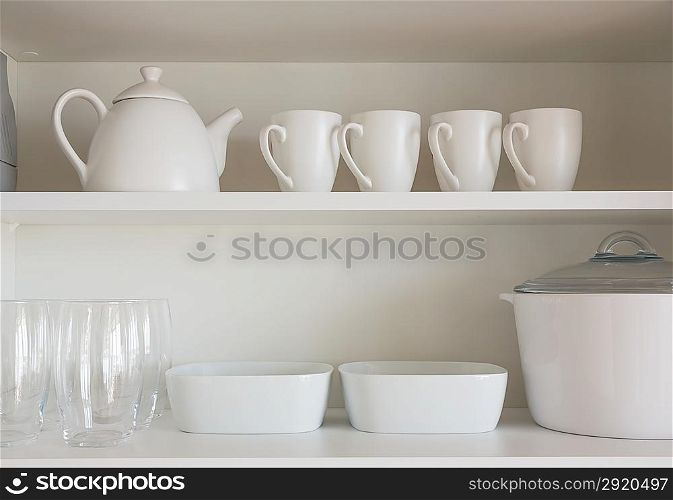 opened cupboard with kitchenware inside