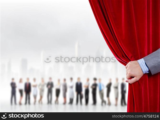 Opened curtain. Hand of businessman opening red velvet curtain