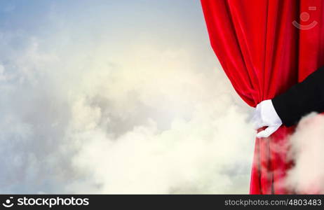 Opened curtain. Hand of businessman opening red velvet curtain