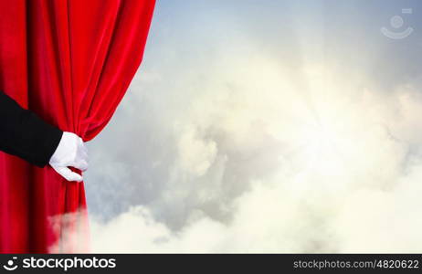 Opened curtain. Hand of businessman opening red velvet curtain