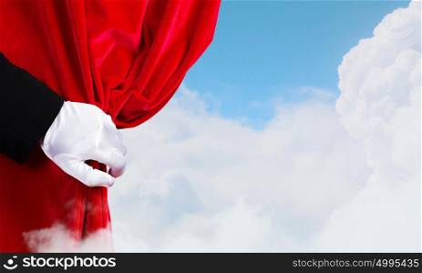 Opened curtain. Hand of businessman opening red velvet curtain