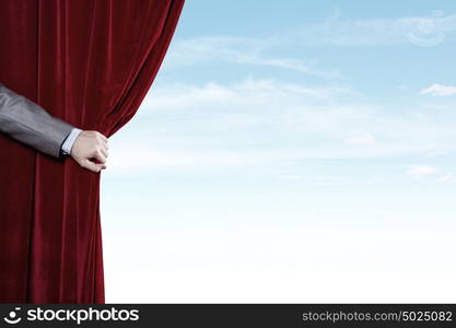 Opened curtain. Hand of businessman opening red velvet curtain