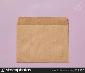 Opened empty craft brown Recycle envelope isolated on pink background as business concept with copy space, flat lay. Opened brown Recycle envelope isolated on pink background
