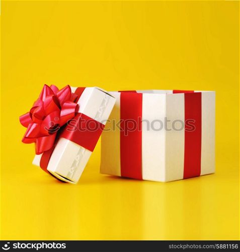 opened gift box close up isolated on yellow background