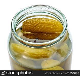opened glass jar of green pickled cucumbers