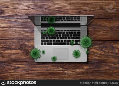 Opened laptop on a wooden table with flying molecules of Coronavirus, Covid-19, copy space. Top view. Working home, outside office concept.. Notebook with flying bacteria of Coronavirus.