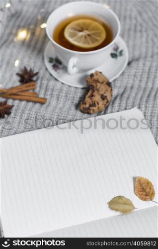 opened notebook near tea cup